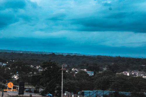 a view of a city with trees and a cloudy sky at 5 PM Hotel in Nairobi