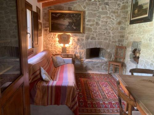 a living room with a couch and a fireplace at Casa tipica sarda in Gonnosnò