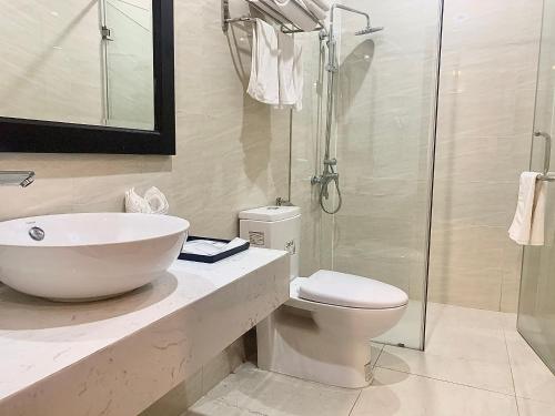 a bathroom with a sink and a toilet and a shower at Paragon House and Residence in Hanoi