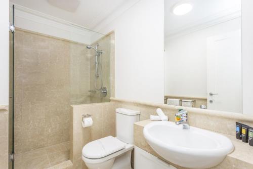 a bathroom with a toilet and a sink and a shower at Cottesloe Aqua Retreat - Executive Escapes in Perth