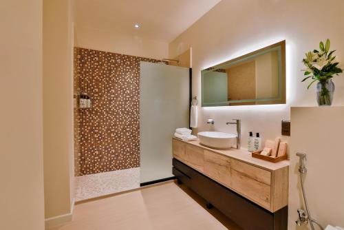 a bathroom with a sink and a shower at Cloud 7 Residence AlUla in AlUla