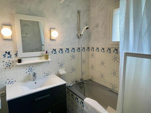 a bathroom with a sink and a tub and a shower at Holiday house with garden and terrace close to the ocean in Lacanau-Ocean in Lacanau