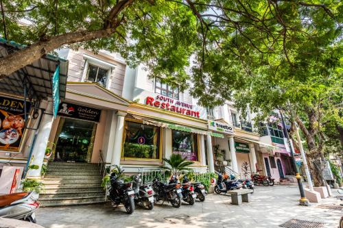 a row of motorcycles parked in front of a building at Treebo Trend South Avenue 700 Mts From Promenade Beach in Puducherry