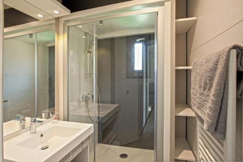 a bathroom with a glass shower and a sink at Casa e Natura in Moriani Plage