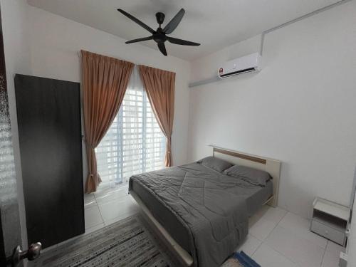 a bedroom with a bed and a ceiling fan at MamaShy Homestay Manjung -FREE WIFI- in Seri Manjung