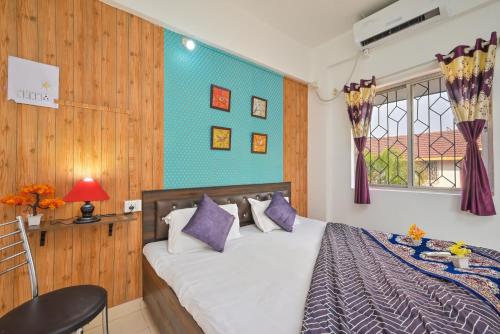 a bedroom with a bed and a window at EMPYREAN STAY II 2BHK II AC II POOL II SANAM VILLA ll in Lonavala