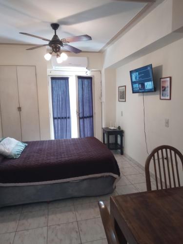 a bedroom with a bed and a ceiling fan at Alquiler temporal in San Miguel de Tucumán