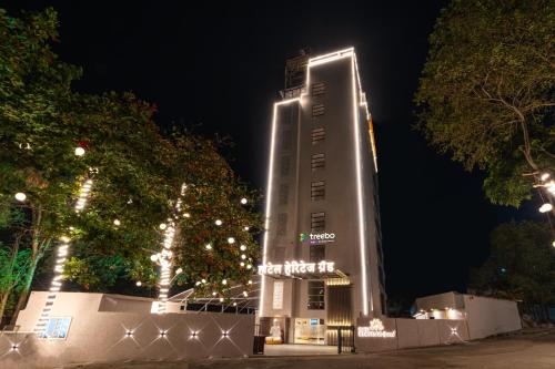 a tall building with lights on it at night at Treebo Tryst Heritage Grand - Thane in Mumbai