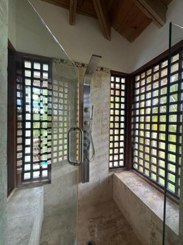 a bathroom with a shower with a glass door at Golf Views Near Bayahibe & Casa De Campo in La Romana
