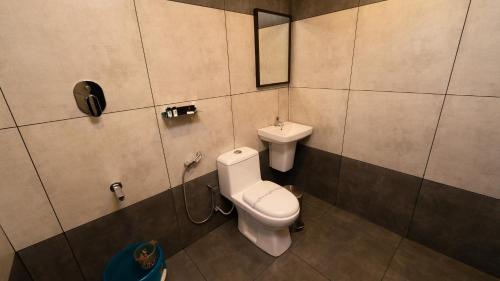 a bathroom with a toilet and a sink at Vayalada View Point Resort in Kozhikode