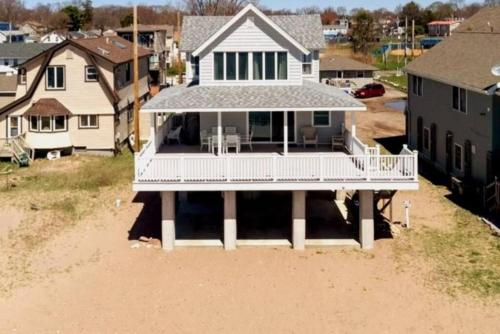 an aerial view of a house in the sand at Cozy Beach - Direct Waterfront! in East Haven