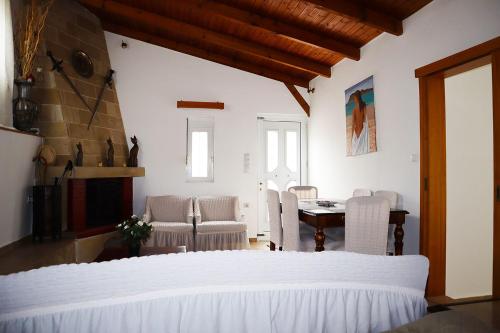 a bedroom with a bed and a table and chairs at Villarosa Calma apartment in Stavros