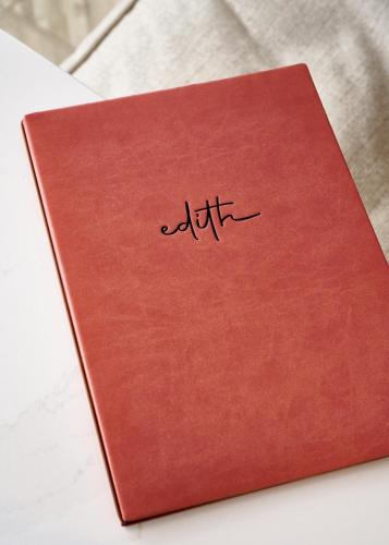 a red notebook with the word autism written on it at Padam Hôtel in Paris