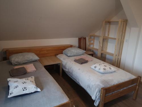 two twin beds in a small room with at Small house in Celje in Celje
