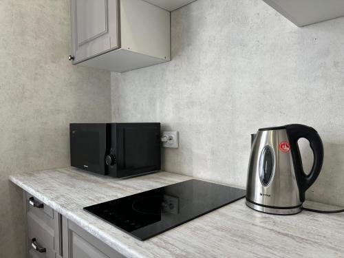 a kitchen counter with a microwave and a toaster at ЖК Ауэзова1 in Kokshetau