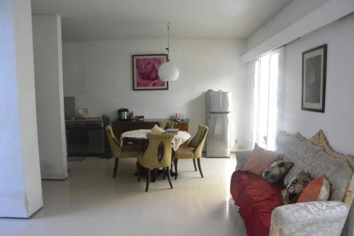 a living room with a couch and a table at Bracha house in Legian