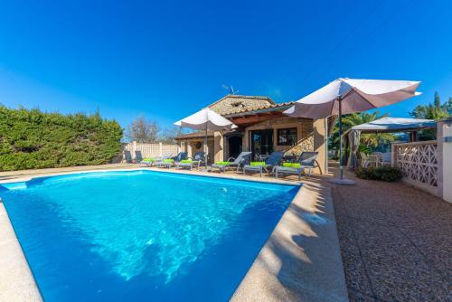 a swimming pool in front of a house at Can Antich in Lloseta