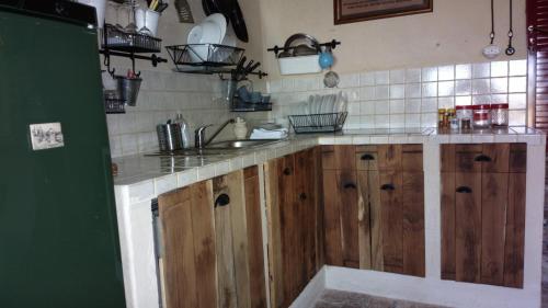a kitchen with wooden cabinets and a sink at Studio-apartments Monfort in Portorož