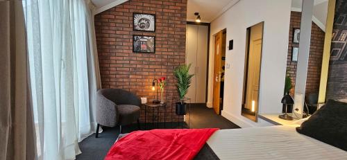 a hotel room with a bed and a brick wall at Hotel Spa El Muelle de Suances in Suances