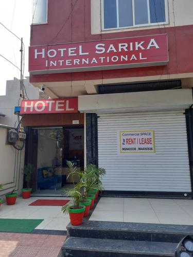 a hotel santa ana international sign on the front of a building at Hotel Sarika International in Indore