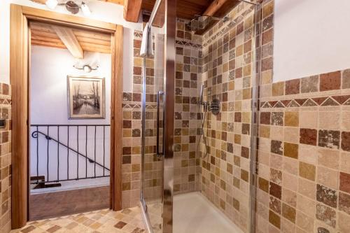 a bathroom with a shower with a glass door at HelloChalet - Duplex Maison Loz with balcony in Valtournenche
