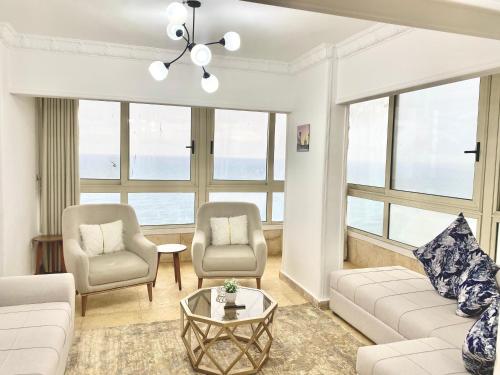 a living room with a couch and two chairs and a table at Alexandria Luxury Apartments Stanley Direct Sea View in Alexandria