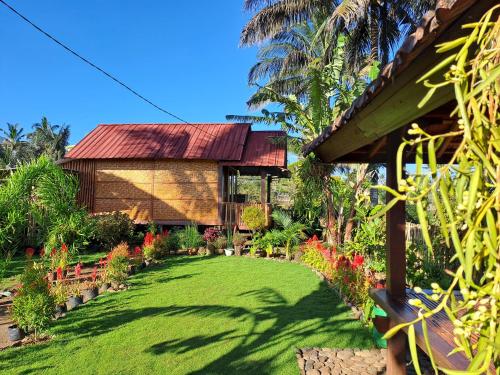 a house with a lawn in front of it at Kurni's Cabin in Sapit