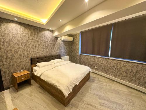 a bedroom with a bed and a large window at GRAND LOFT OTEL in Bursa