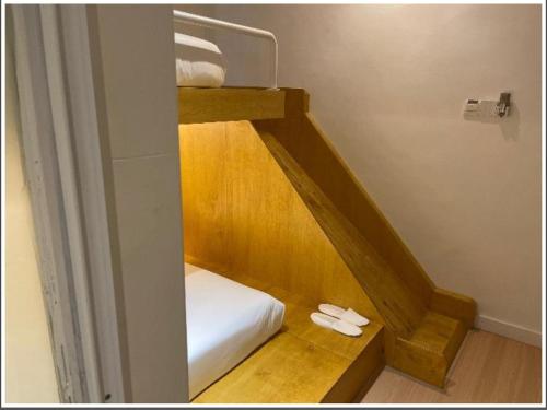 a room with two bunk beds with slippers on the floor at Double H Boutique Hotel in Kuala Terengganu