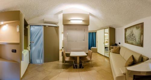 a hospital room with a table and a desk at Calanica Resort in Cefalù