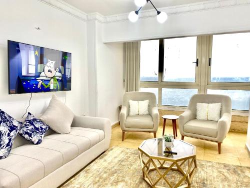 a living room with a couch and two chairs at Alexandria Luxury Apartments Stanley Direct Sea View in Alexandria