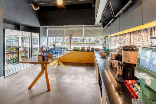a large kitchen with a counter in a store at Aloft Jacksonville Tapestry Park in Jacksonville