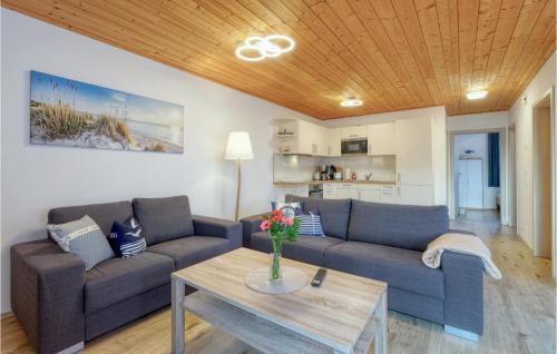 a living room with two couches and a table at Ferienhaus 41 Altefähr in Altefähr