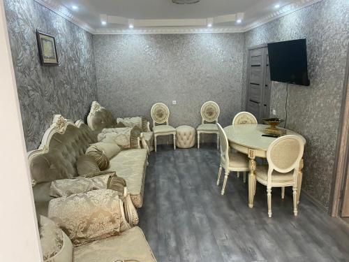a living room with a couch and a table and chairs at Нара in Gyumri