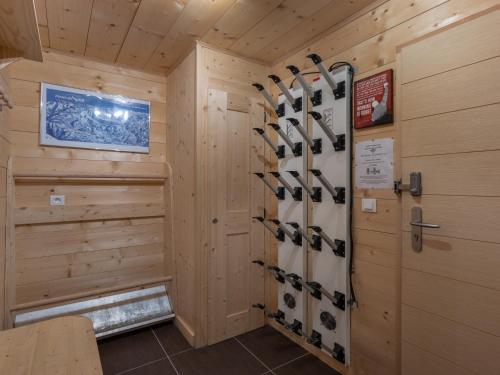 a cabin with ski equipment in a room at Etringa 8 - Chalet Mitoyen - BO Immobilier- remises sur les forfaits de skis Châtel ou Portes du soleil in Châtel