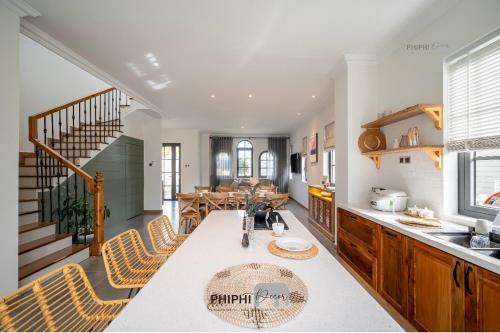 a kitchen and dining room with a table and chairs at La Mer Villa in Bình Tú