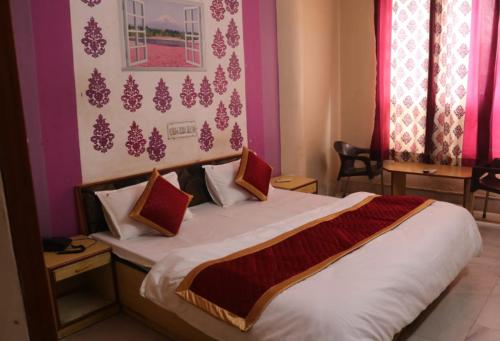 a bedroom with a large bed in a room at Hotel Kirti Plaza in Chittaurgarh