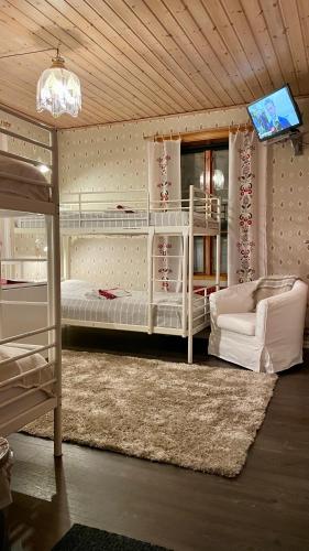a bedroom with two bunk beds and a tv at Prinsgården B&B rum stugor in Mora