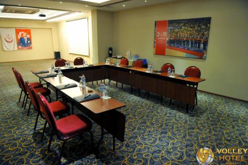 a meeting room with long tables and red chairs at VOLLEY HOTEL ANKARA in Ankara