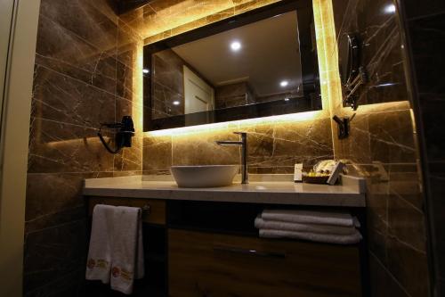 a bathroom with a sink and a mirror at VOLLEY HOTEL ANKARA in Ankara