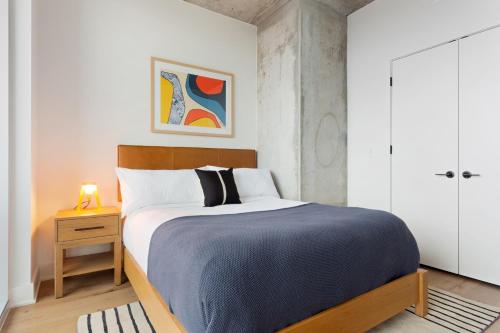 a bedroom with a bed with a blue blanket at Stubbs by AvantStay Brand New Condo in Austin w Amazing Amenities in Austin