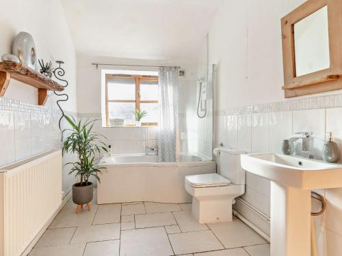a bathroom with a sink and a toilet and a bath tub at 3 Bed in Gower 93942 in Ilston