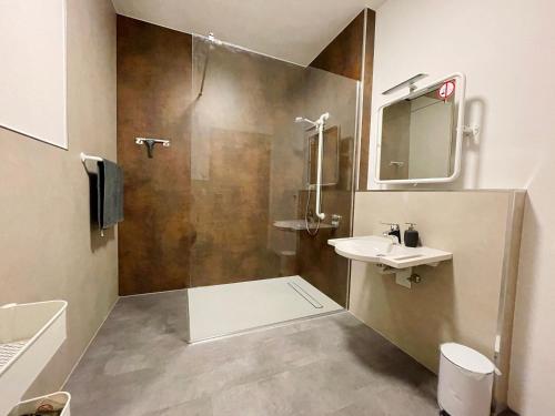 a bathroom with a shower and a sink and a mirror at Maiglöckchen in Großrinderfeld