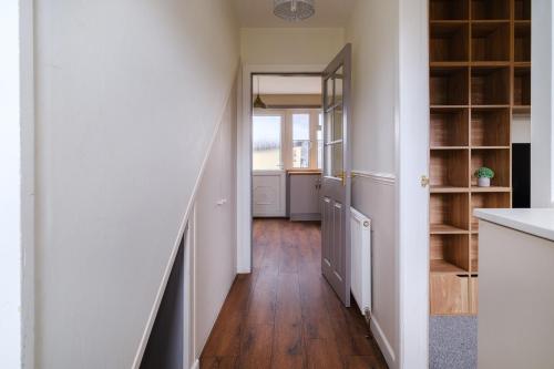 a hallway with white walls and wooden floors at Banchory House - SJA Stays - 2 Bed Apartment in Banchory