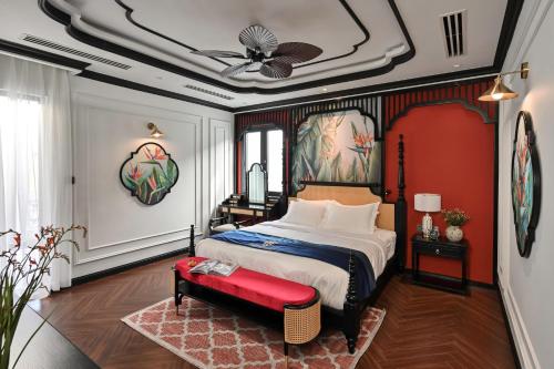 a bedroom with a bed and a red wall at Thiên Ân Boutique Hotel in Bạc Liêu