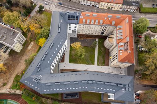 an overhead view of a building with a roof at MILESTONE Krakow Center Urban Living in Krakow