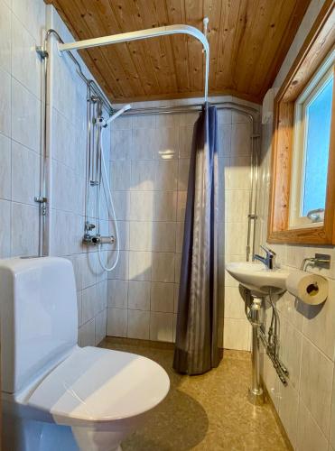 a bathroom with a toilet and a sink at Urshult Camping in Urshult