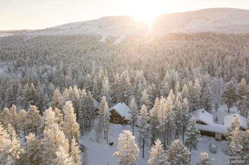 una vista aérea de un bosque cubierto de nieve con una casa en Holiday in Lapland - Kuksatie 15A, en Levi