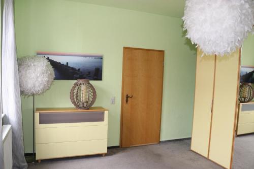 a room with a door and a vase on a table at XXL Ferienliebe in Habrachćicy