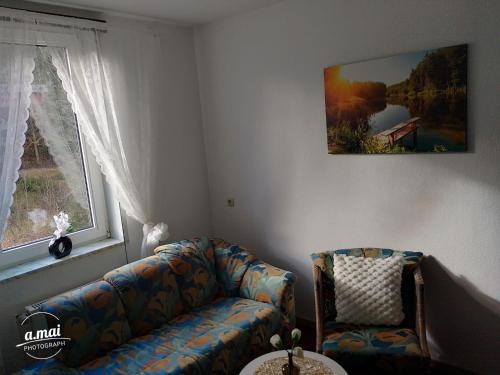 a living room with a couch and a window at Harzklub Wanderheim in Wildemann